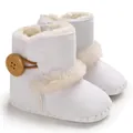 Close-up detail of white infant winter snow boots featuring soft faux fur and wooden button - 11cm / White