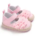 Close-up of pink ruffled princess baby walking shoes with soft soles and velcro - Pink