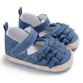 Close-up of blue denim baby girl shoes with elegant ruffle design and soft sole - Blue