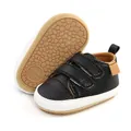Detailed view of black faux leather baby pre-walker shoes showing velcro straps and sole - 12cm / Black