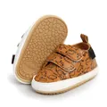 Detailed macro view of brown dinosaur pattern baby walking shoes with anti-slip rubber sole - 12cm / Dinosaur / Brown Print