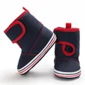 Detail view of navy blue and red soft-sole baby walking boots with velcro straps - Dark Blue