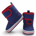 Detail view of blue infant toddler boots with red trim and velcro straps for warmth - Light Blue