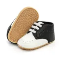 Detail view of classic black and white soft-sole baby pre-walker shoes with anti-slip grip sole - 12cm / White Black