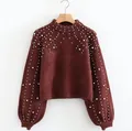 Detailed view of women's burgundy knit pullover sweater with white pearl embellishments - S / Tops / Burgundy