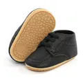 Detailed view of black PU leather baby shoes with non-slip soft rubber soles - 12cm / Black