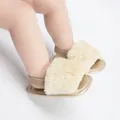 Close-up of fluffy faux fur baby sandals with elastic heel strap - Coffee