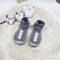 Soft sole grey baby walking sock shoes featuring comfortable knitted fabric and SELF-CARE label - Size 18/19 / Label Style / Gray with Label