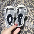 Comfortable plaid baby walking sock shoes with non-slip soft soles for infants and toddlers - Size 20/21 (Inner Length 12.5cm) / Black Grid