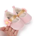 Close-up detail of pink soft baby pre-walker shoes featuring a crochet flower and gold strap - Insole Length 11cm / Pink