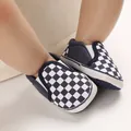 Close-up detail of baby checkerboard slip-on walking shoes with a soft flexible sole - Dark Blue