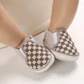 Detail of soft-soled brown checkered slip-on infant walker shoes for 0-1 year olds. - Gray