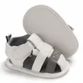 Detailed view of white soft-sole baby sandals with grey straps and velcro straps - White