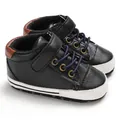 Close-up detail of high-top leather baby walking shoes with soft anti-slip soles - Black