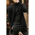 Detail view of men's long black knitted cardigan showcasing the thick knit texture and fit - S / Black