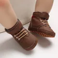 Close-up of brown high-top baby walking shoes with soft dotted soles - Brown