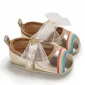 Detailed view of golden baby princess shoes with rainbow embroidery and mesh bow - Gold