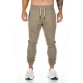 Close-up front view of men's slim-fit joggers in olive green with drawstring waist - M / Bottoms / Khaki