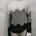 Detail view of a tricolor knit sweater with wave patterns and color blocking. - White Gray Navy Block