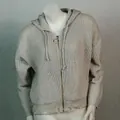 Detailaufnahme grauer Kapuzenstrickpullover mit Distressed-Saum und Ringreißverschluss - Grauweiß