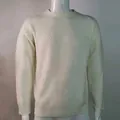 Close-up detail of cream slim fit knitted sweater featuring unique diagonal ribbed texture - S / Tops / White