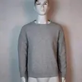Close-up detail of the grey textured knit pattern on a men's crewneck long sleeve sweater. - Light Gray