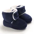 Close-up detail of navy corduroy baby winter boots with soft white fleece lining - 11cm / Blue