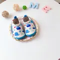 Detailed view of baby slip-on canvas walking shoes featuring cute blue whale and nautical print - Whale and Cruise