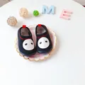 Detailed view of black minimalist pig face slip-on shoes for toddlers on a decorative plate - Cartoon Print