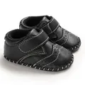 Detailed view of black infant walker shoes with white hand-stitched detailing and velcro strap - Black