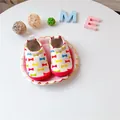 Detailed view of baby walking shoes with colorful bowtie pattern on a white background. - Colorful Butterfly