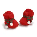 Detailed view of red fuzzy Christmas baby boots with striped scarf and white pom-poms - Red