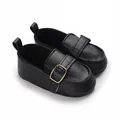 Detailed view of black faux leather baby shoes with a stylish golden buckle accent - Black