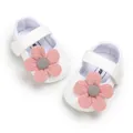 Detailed top view of white knitted baby girl princess shoes with pink crochet flowers - 11cm / White