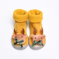 Close-up of baby walking shoes featuring a plush 3D reindeer design and green ribbon bows - Deer Decoration