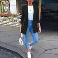 Women's elegant black mid-length blazer jacket shown in a stylish street setting. - S / Tops / Black