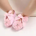 Macro detail view of pink baby princess walker shoes with lace flower and ribbon bow - Insole Length 11cm / Pink