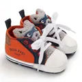 Detail of orange cartoon baby walker shoes with HELLO BABY text and white laces - Brown