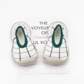 Top view detail of breathable grid knit baby walker shoes with soft green trim rubber soles - White Plaid
