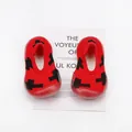 Close-up detail of red breathable baby sock shoes with soft non-slip soles for active toddlers. - Red Cross