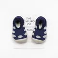 Detailed top view of navy polka dot knit baby walking shoes with soft rubber soles - Navy Blue Polka Dots