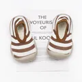 Close-up of brown and white striped toddler walking shoes with breathable soft soles - Yellow White Stripes