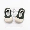 Detailed close-up of breathable knit toddler sock shoes with flexible soft rubber soles - Dark Green Patchwork