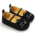 Close-up of black baby walking shoes with cute cat embroidery and soft gold lining. - Black