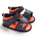 Detail view of navy blue infant shark sandals with soft soles and velcro straps. - Dark Blue