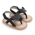 Close-up detail of black butterfly glitter baby sandals with soft soles for summer - Black