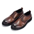 Detail view showing the handcrafted vintage brown leather texture of these men's derby shoes - 38 / Brown