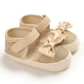 Side detail view of gold glitter baby walker shoes with patent leather bows - Inner Length 11cm / Gold