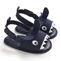 Detailed close-up view of navy blue baby shark sandals featuring soft soles and canvas material - Blue