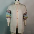 Detailed view of white mohair cardigan with colorful striped knit sleeves on mannequin - S / Tops / Off White